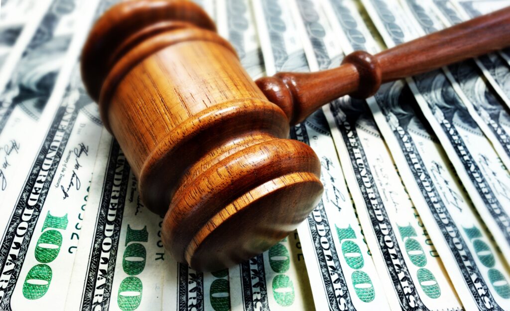 Fanned out $100 bills with gavel on top