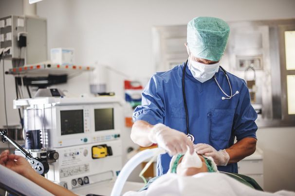 Anesthesiologist preparing patient for surgery