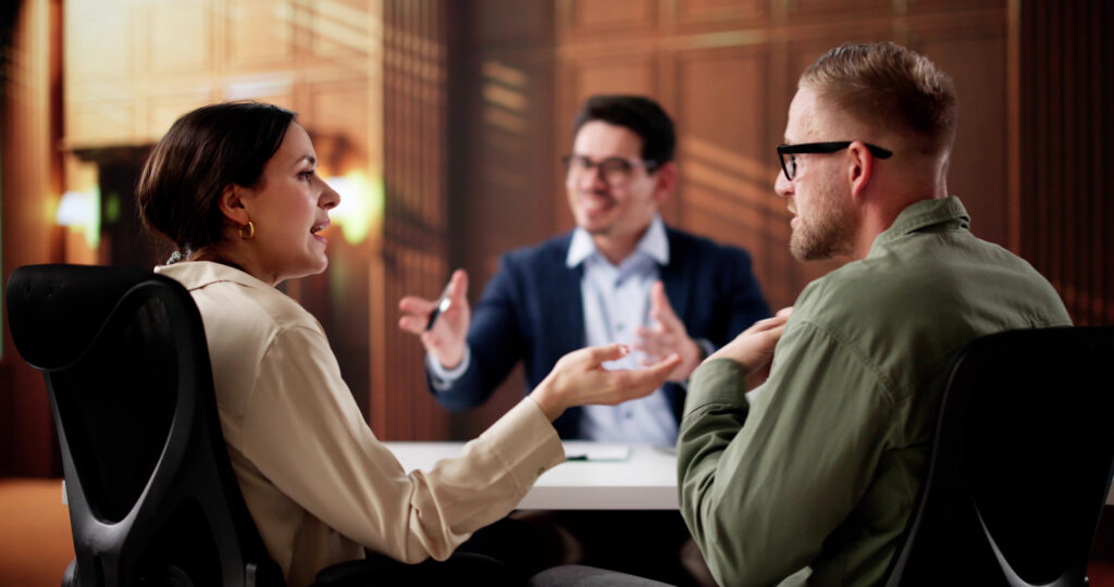 Mediator facilitating negotiations between man and woman at table