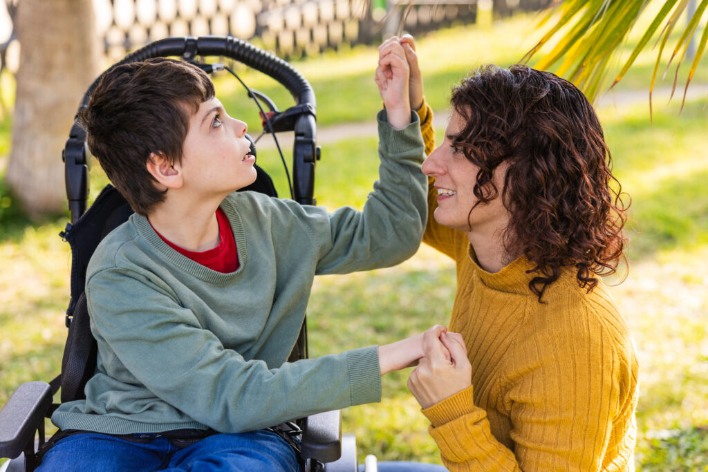 Woman playing with disabled child